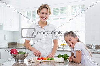 Mother and daughter preparing vegetables