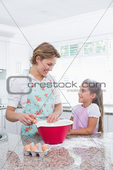 Mother and daughter baking together