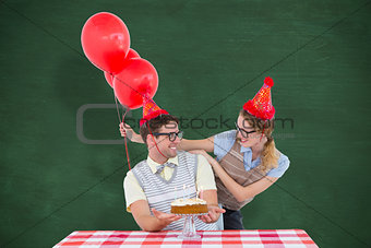 Composite image of geeky hipster couple celebrating his birthday