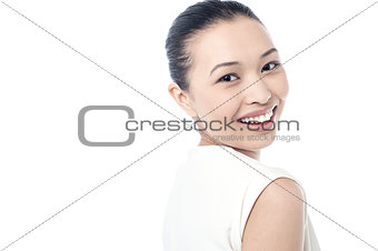 Young woman smiling against white