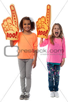 Little girls raises arms with foam finger