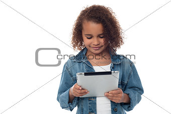Llittle girl looking digital tablet