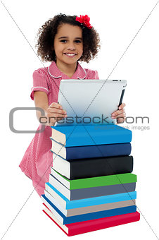 Cute little curly haired girl using tablet pc