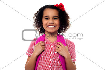 Smiling school girl with a backpack