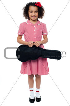 Smiling school girl with guitar