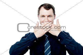 Businessman covering his mouth with hands