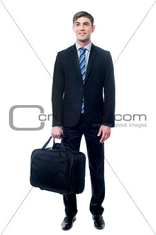 Businessman in black suit posing with bag