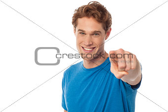 Cheerful man pointing towards camera