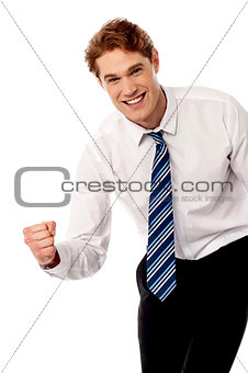 Enthusiastic corporate man clenching fist