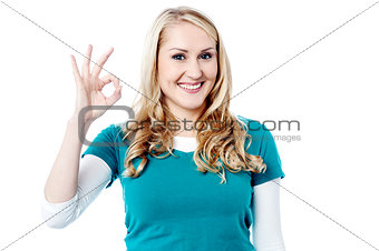 Young woman shows Okay gesture