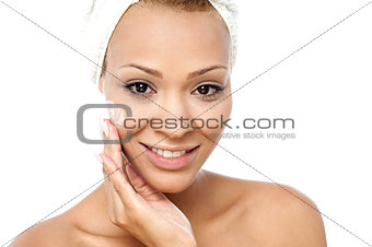 Beautiful woman applying moisturizer
