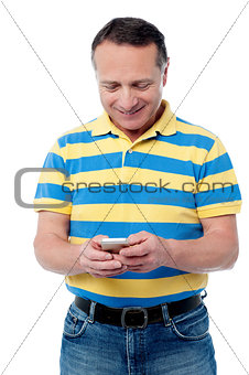 Casual aged man using mobile phone