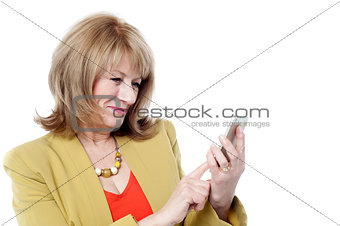 Senior woman looking at her cell phone