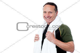 Aged male trainer posing after his workout