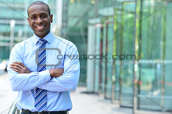 Confident businessman with arms crossed