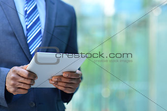 Cropped image of businesman with digital tablet
