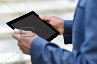 Businessman holding digital tablet outdoors