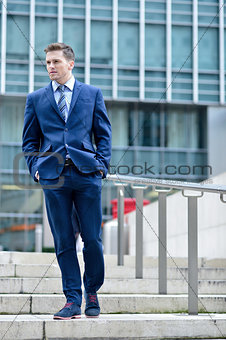 Corporate guy walking down the stairs