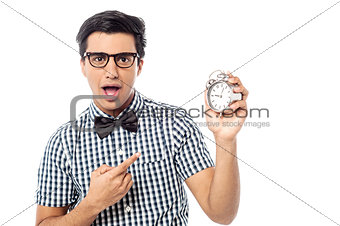 Excited man holding an antique clock