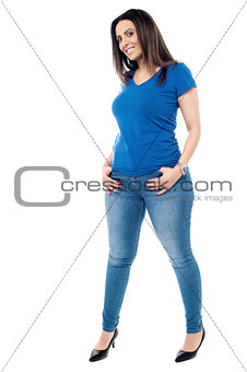 Young casual woman standing isolated on white