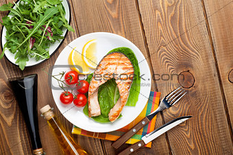 Grilled salmon, salad and condiments