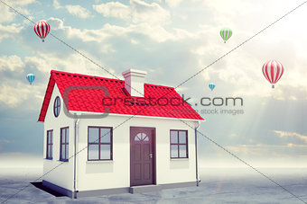 White house with red roof and chimney. Background sun shines brightly