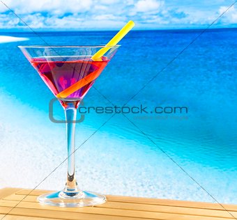 red cocktail on wood table and space for text