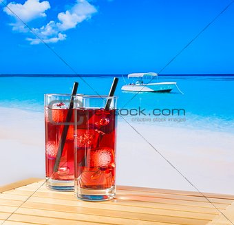 two glasses of red cocktail with straw and space for text