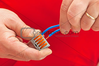 Electrician hands making a connection