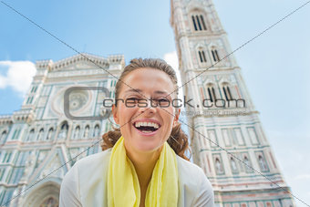 Portrait of happy young woman in front of duomo in florence, ita