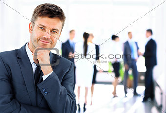 Portrait of young handsome businessman in office