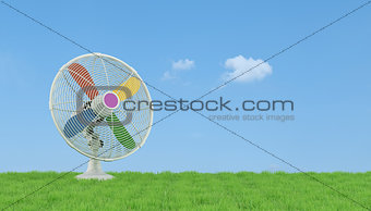 Colorful electric fan on grass