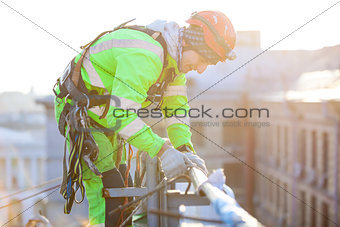 Industrial climbers working on roof of building