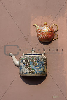 Ancient teapots on facade of old building in Vilnius, Lithuania.