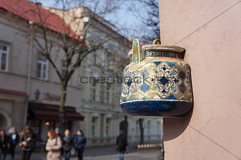 Ancient teapot on facade of old building in Vilnius, Lithuania.