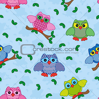 Seamless pattern with ornamental owls over blue