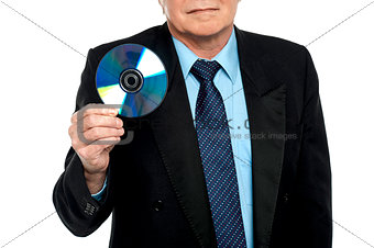 Cropped image of a male showing compact disk