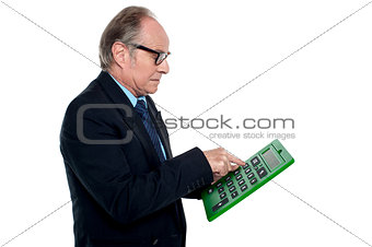 Intent looking executive working on a calculator