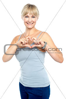 Romantic middle aged woman gesturing heart shape