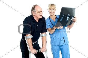 Surgeon showing x-ray sheet to her patient