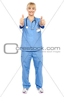 Cheerful lady doctor showing double thumbs up