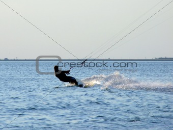 Silhouette of a kite-surf on waves of a gulf 2