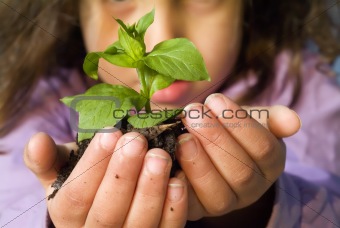 girl holding plant