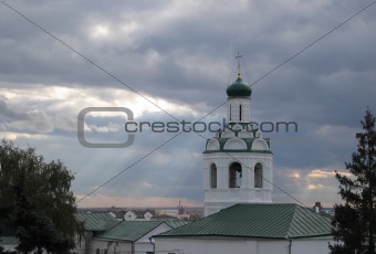 Sun beams through clouds over church