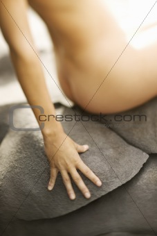 Nude woman on rock.