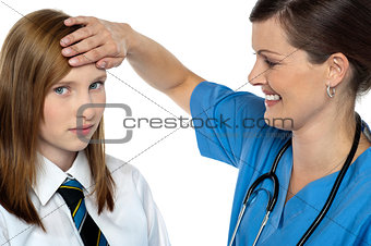 Doctor placing her hand on a patients forehead