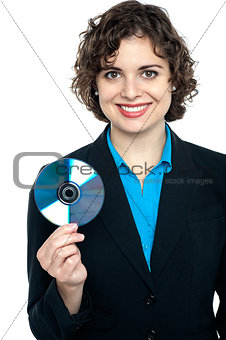 Charming corporate lady holding data disc