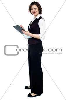 Charming business lady posing with a clipboard