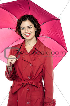 Fashionable young model posing with an umbrella