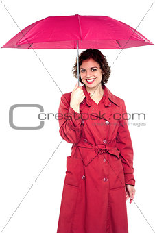 Young fashionable woman holding an umbrella